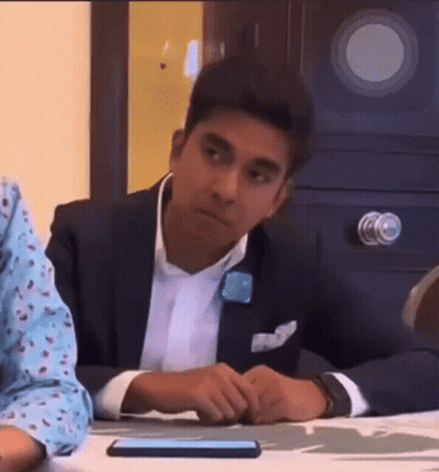 Man In Suit Sitting At Table With Hands Folded GIF