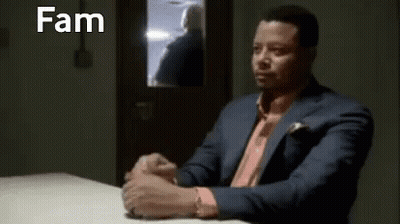 Man In Suit Sitting At Table With Hands Folded GIF
