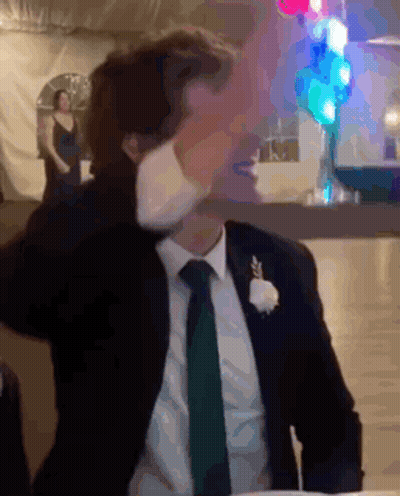 Man In Suit Sitting At Table With Hands On Head GIF