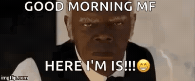 Man In Suit Sitting At Table With Homo Things Sign GIF