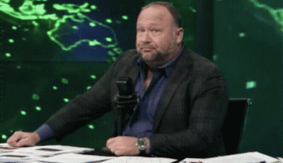 Man In Suit Sitting At Table With Microphone GIF