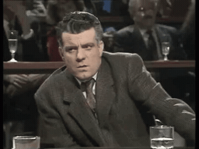 Man In Suit Sitting At Table With Water GIF