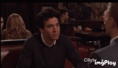 Man In Suit Sitting At Table With Woman In Red Dress GIF