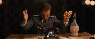 Man In Suit Sitting At Table With Word Make Behind GIF