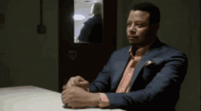 Man In Suit Sitting At Table GIF