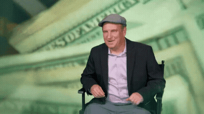 Man In Suit Sitting Before Money GIF