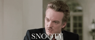 Man In Suit Sitting Before Snooty Wall GIF