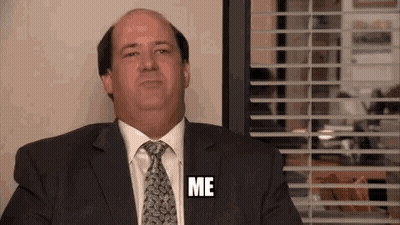 Man In Suit Sitting By Window Saying Me GIF