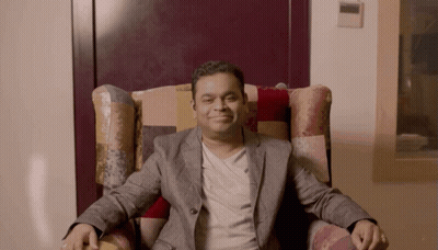 Man in Suit Sitting Crossed Arms