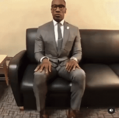 Man In Suit Sitting Crossed Legs GIF