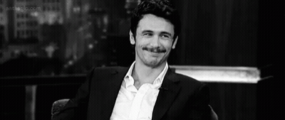 Man In Suit Sitting GIF