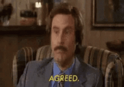 Man In Suit Sitting Eyes Closed Saying Agreed GIF
