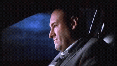 Man In Suit Sitting In Back Seat Of Car At Night GIF