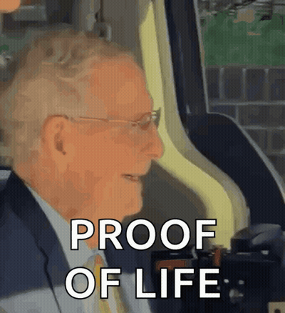 Man in Suit Sitting in Car Says Proof of Life