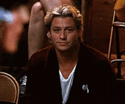 Man In Suit Sitting In Chair Looking At Camera GIF