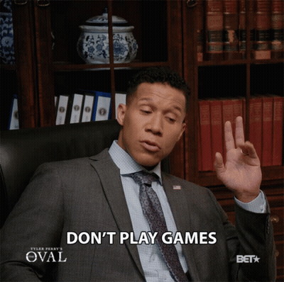 Man In Suit Sitting In Chair Saying Don't Play Games GIF