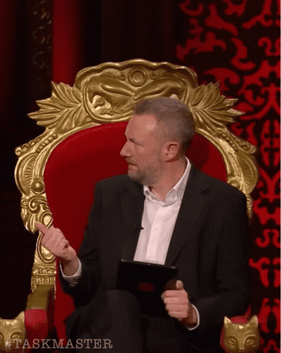 Man In Suit Sitting In Chair Taskmaster GIF