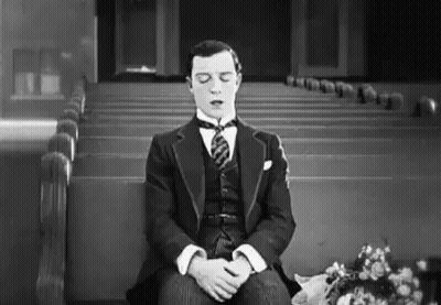 Man In Suit Sitting In Church Eyes Closed GIF