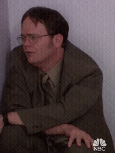 Man In Suit Sitting In Corner GIF