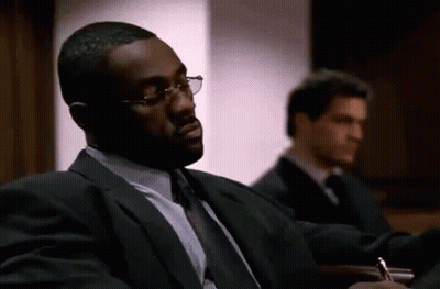 Man In Suit Sitting In Courtroom With Another Man GIF