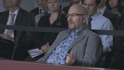 Man In Suit Sitting In Crowd Saying I'm Just A Lad GIF