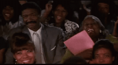 Man In Suit Sitting In Crowd Watching Show GIF