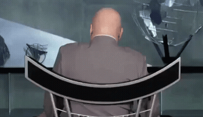 Man In Suit Sitting In Curved Chair GIF