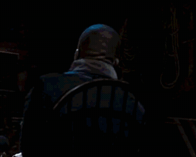 Man In Suit Sitting In Dark Room GIF