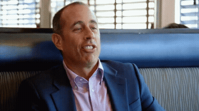 Man In Suit Sitting In Diner Booth GIF