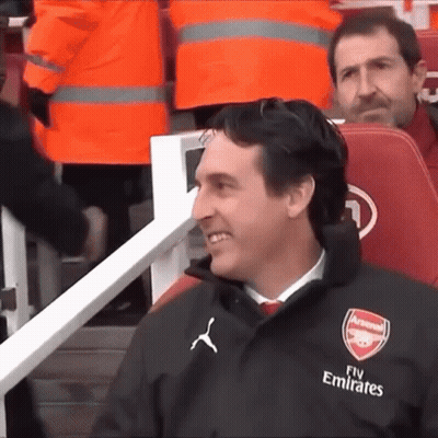 Man In Suit Sitting In Empty Stadium With Arsenal Media GIF