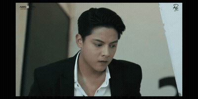Man In Suit Sitting In Front Of ABS CBN Screen GIF