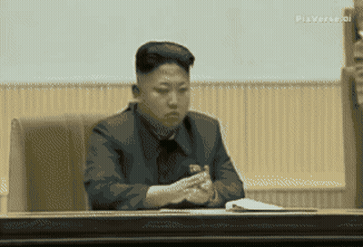 Man In Suit Sitting In Front Of Another Man GIF