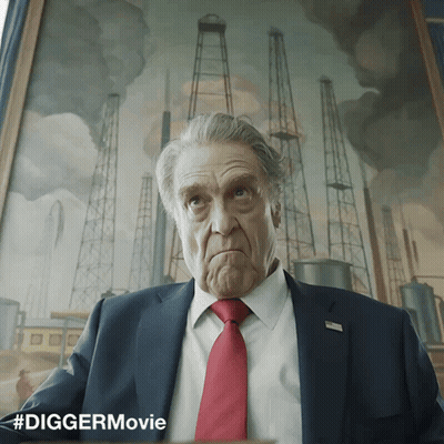 Man In Suit Sitting In Front Of #Diggermovie Painting GIF