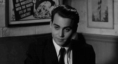 Man In Suit Sitting In Front Of Eye Of Camera Poster GIF