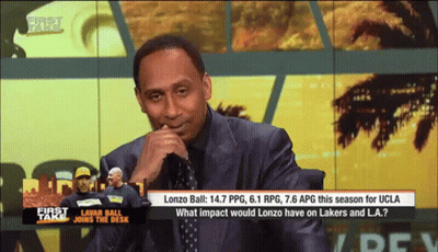 Man In Suit Sitting In Front Of First Take Screen GIF
