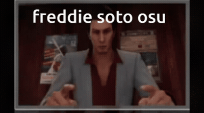 Man In Suit Sitting In Front Of Freddie Soto OSU Screen GIF