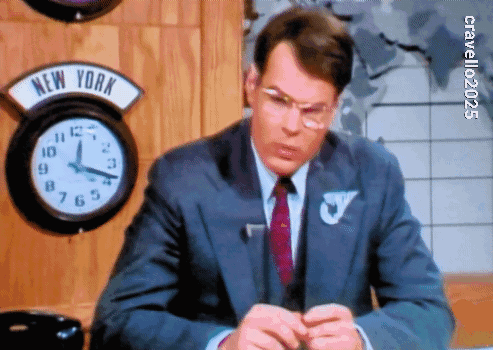 Man In Suit Sitting In Front Of New York Clock GIF
