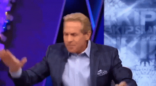 Man In Suit Sitting In Front Of Skip Span Sign GIF