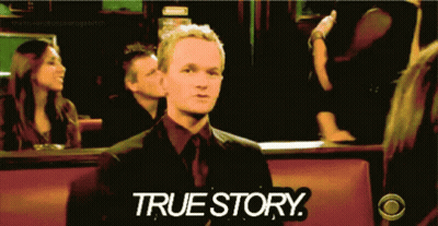 Man In Suit Sitting In Front Of True Story Sign GIF