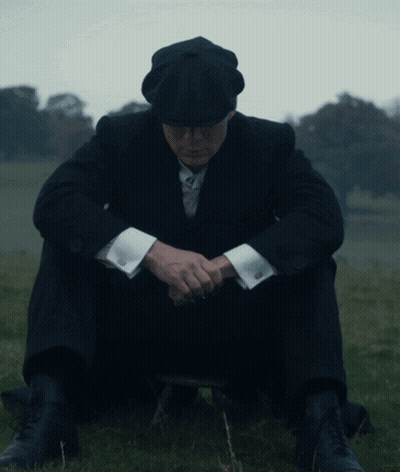 Man In Suit Sitting In Grass With Head Down GIF