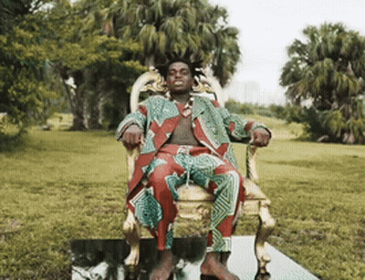 Man In Suit Sitting In Park Chair GIF