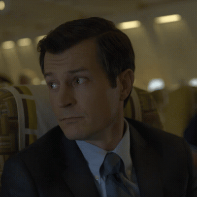Man In Suit Sitting In Plane GIF