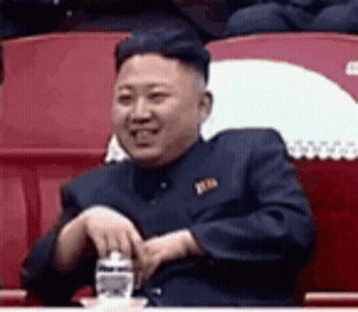 Man In Suit Sitting In Stadium Holding Water GIF