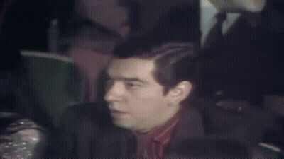 Man In Suit Sitting In Stadium GIF