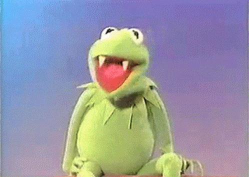 Man In Suit Sitting Next To Muppet Frog GIF