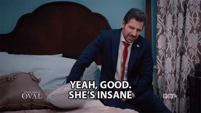 Man In Suit Sitting On Bed Says Yeah Good She's Insane GIF