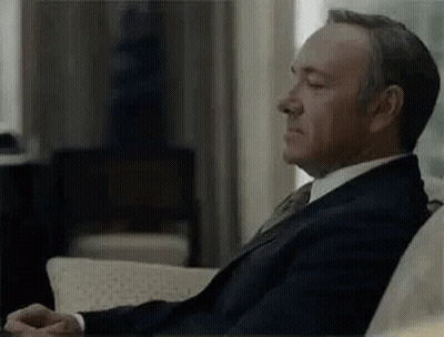 Man In Suit Sitting On Couch GIF