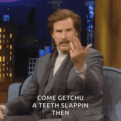 Man In Suit Sitting On Couch Giving Middle Finger GIF
