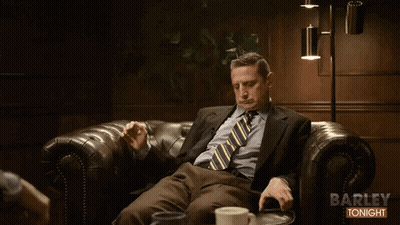 Man In Suit Sitting On Couch Saying Barley Tonight GIF