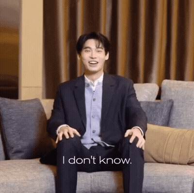 Man In Suit Sitting On Couch Saying I Don't Know GIF